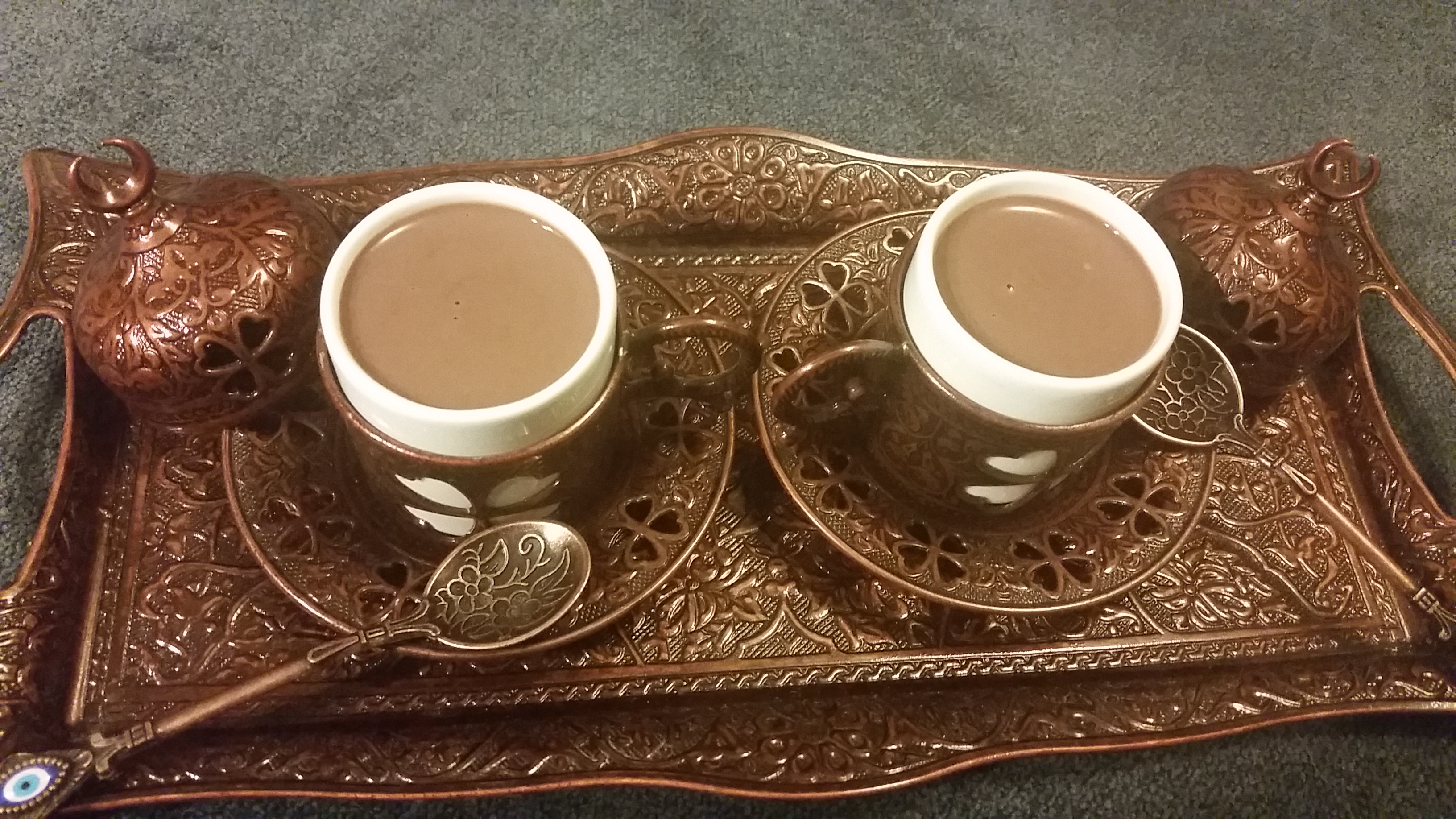 Two Turkish Coffee Cups in bronze on a bronze tray, filled with thick drinking chocolate.
