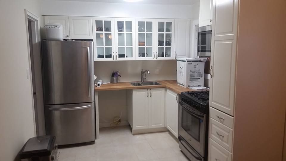 The new kitchen, the day it was delcared done. Complete with empty cabinets, boxes and no dishwasher.