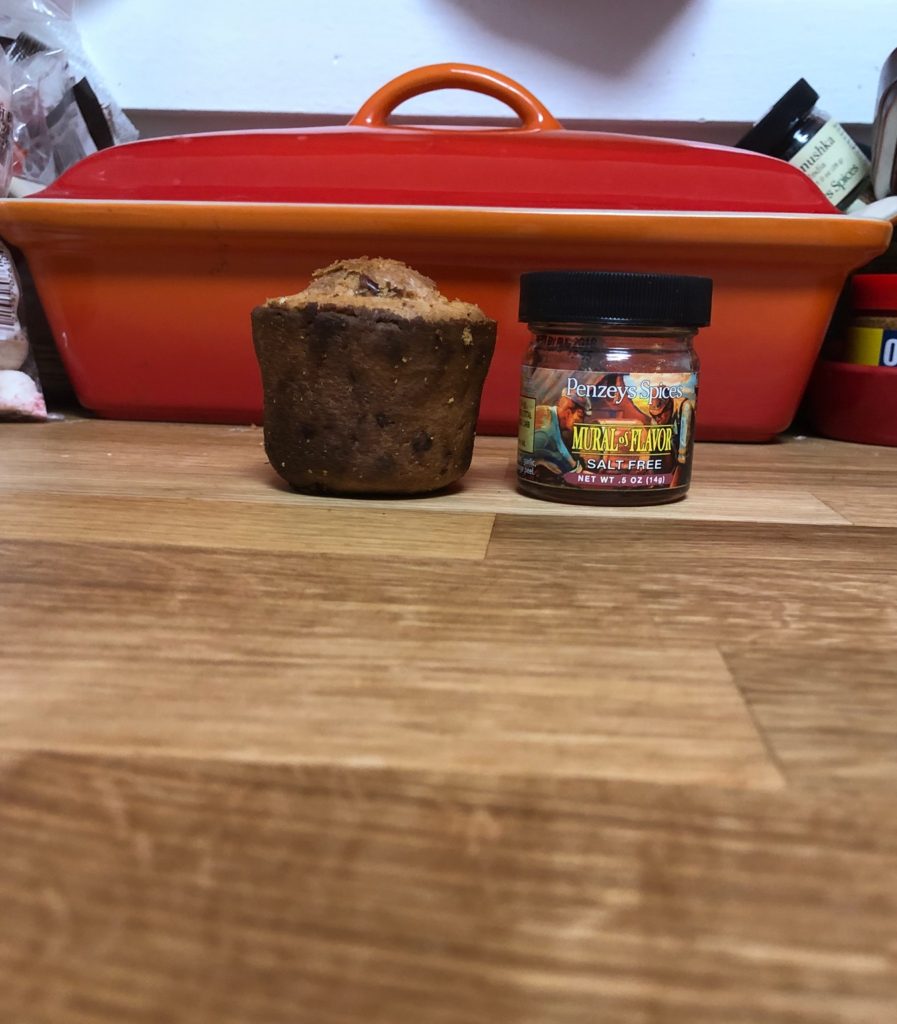 A sad popover that looks more like a muffin, sitting next to a small Penzy's spice jar - they are SADLY the same size.
