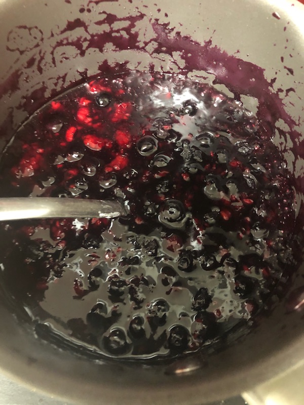 A mix of blueberries and raspberries bubbling away on the stove.