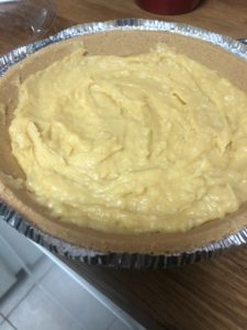 A pie crust only half filled with a messy custard mix.